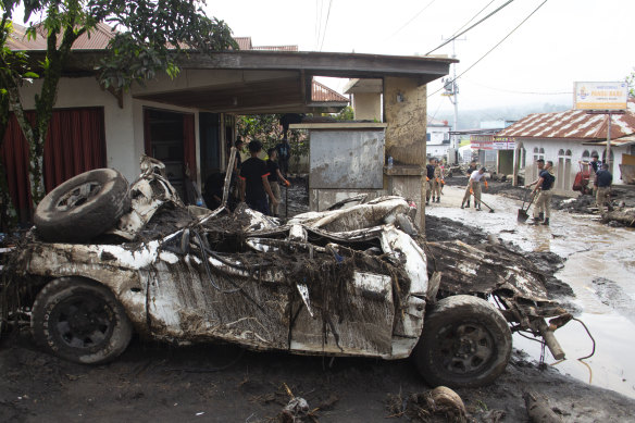 People clean up after a flash flood in Agam, West Sumatra, Indonesia.