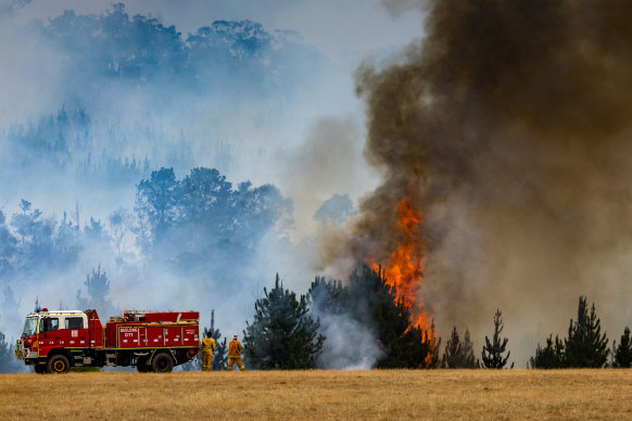 The fire continued to threaten homes on Friday.