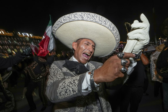 A man dressed in traditional clothing sings after the close of polls at the Zocalo, Mexico City’s main square where supporters of Claudia Sheinbaum gathered.