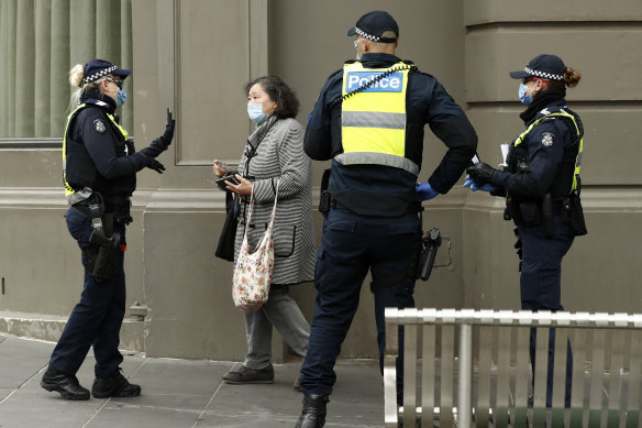 Police officers issue a fine in August 2020 in Melbourne.