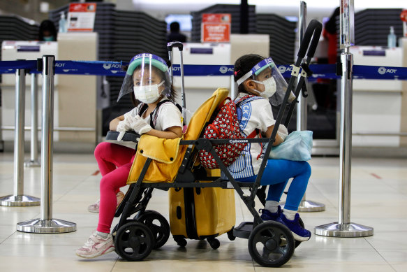 Kids wearing face masks as a preventive measure at Don Muang International Airport during the Coronavirus in Bangkok.