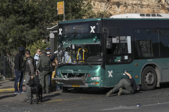 Israeli police inspect the scene of an explosion at a bus stop in Jerusalem on Wednesday.