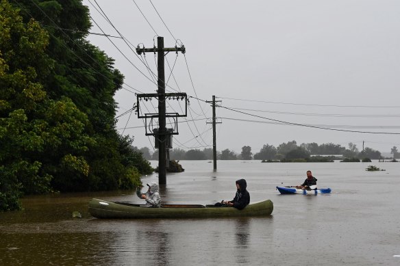 Residents check inundated homes in Windsor as the Hawkesbury River continues to rise on Monday.