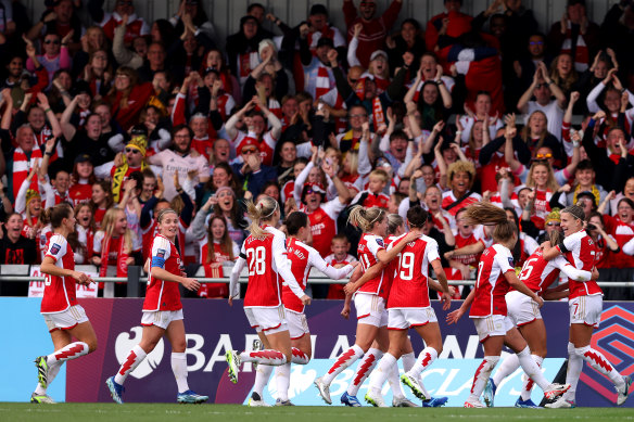 Steph Catley of Arsenal celebrates with teammates after scoring the team’s first goal in England on Sunday.