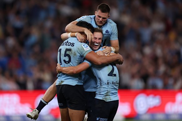 Joseph-Aukuso Suaalii, Jack Bowen and Henry O’Donnell of the Waratahs celebrate victory.