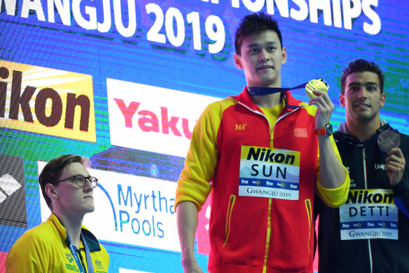 Mack Horton watches Sun Yang during the medal ceremony for the 400m freestyle at the world championships in Gwangju last year.