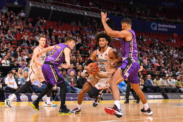 The Taipans’ Keanu Pinder drives for the hoop against the Kings.