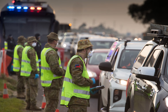 Soldiers and Victoria police on a roadside checkpoint on the Geelong Freeway enforcing lockdown in Melbourne on Friday.