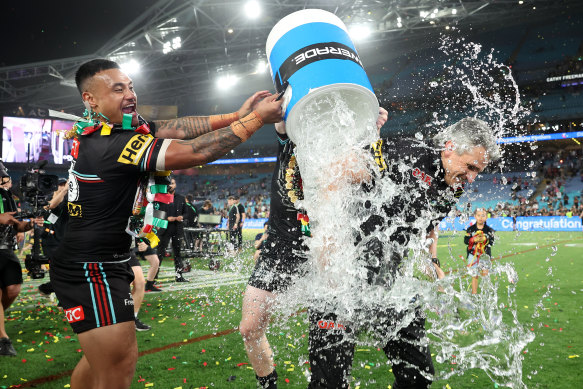 Spencer Leniu pours an ice bucket over Panthers coach Ivan Cleary after their grand final win.