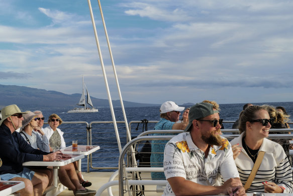 Tourists enjoy a sunset this month near Maalea aboard a catamaran operated by Trilogy, a boating company based on Maui.
