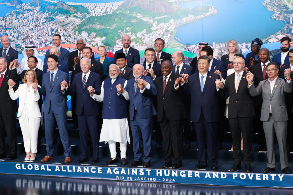 Prime Minister Anthony Albanese (front, second from right), holds hands with China’s Xi Jinping at the G20 summit in Rio de Janeiro, Brazil. 