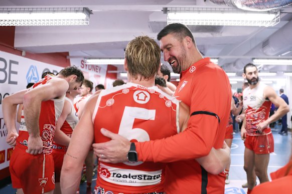 Swans head coach Dean Cox celebrates victory with Isaac Heeney of the Swans.