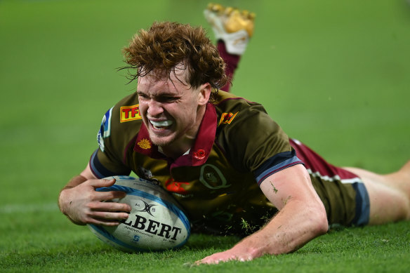 Tim Ryan of the Reds scores a try against the Blues at Suncorp Stadium on Saturday.