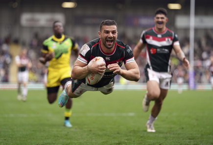 Josh Mansour flies over for a try against Jamaica.