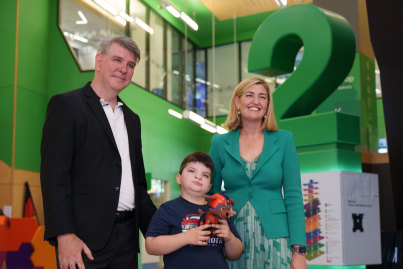Health Minister Shannon Fentiman, with parent advocate Matt Cole and his six-year son Austen, who has had eight surgeries but still started school this year.