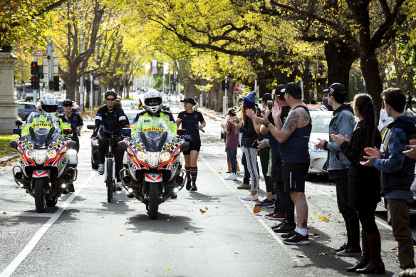 The final group in the relay run down St Kilda Road on Sunday afternoon. 