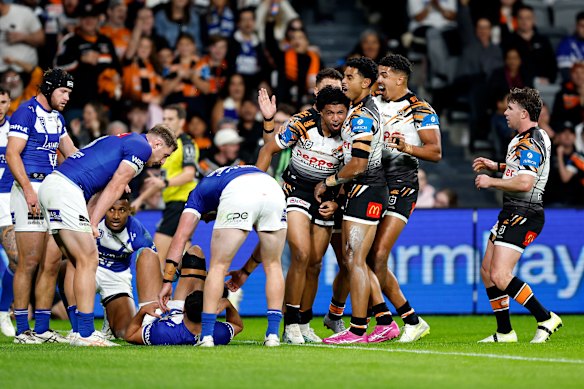 The Tigers celebrate during Saturday’s win over the Bulldogs.