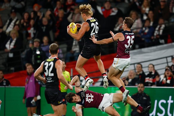 Alix Tauru takes a spectacular mark over Noah Answerth.