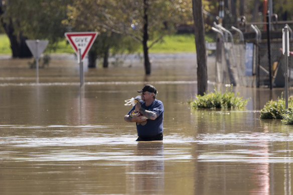 A man walks through floodwater in Gunnedah in 2022.