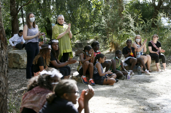 Principal Lois Peeler (in yellow) says Worawa College prepares personalised learning plans and emphasises cultural pride.
