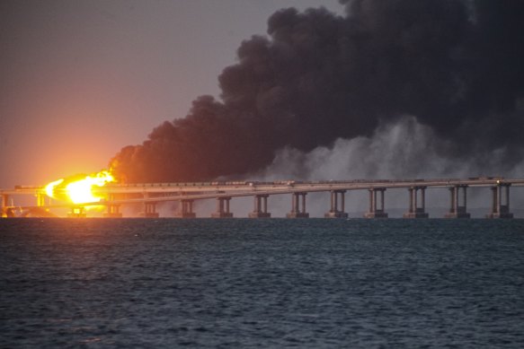 Flame and smoke rise from the Kerch bridge, linking Crimea to the Russian mainland.