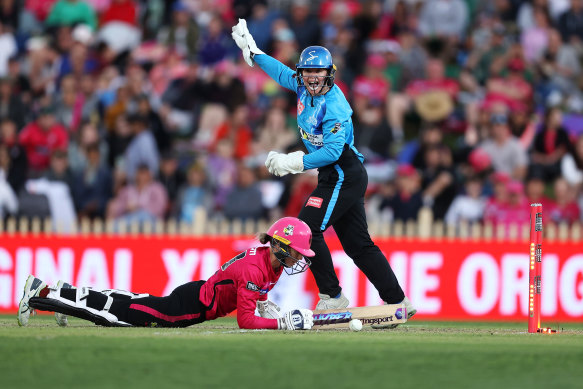 Erin Burns of the Sixers is stumped by Strikers wicketkeeper Tegan McPharlin.