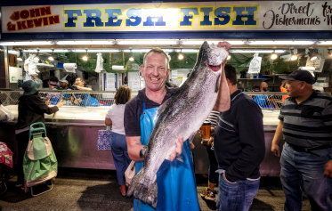 Craig McCluskey, from John & Kevin Fresh Fish, at Footscray Market with an Atlantic salmon. 