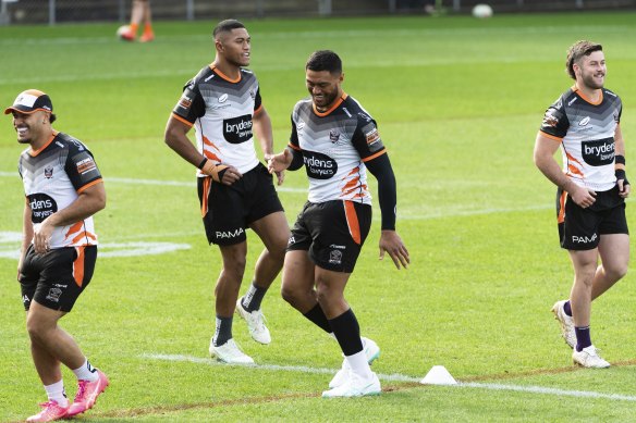 Stefano Utoikamanu stretches out at Wests Tigers’ training on Friday.