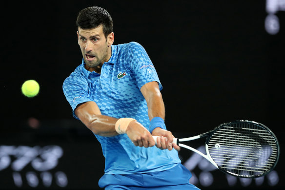 Novak Djokovic plays a backhand.