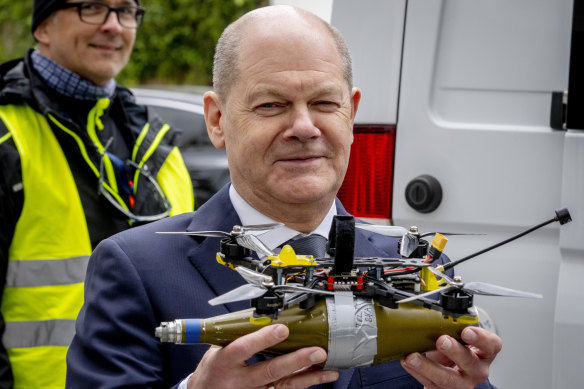 German Chancellor Olaf Scholz, pictured with a replica of a drone used in the war in Ukraine, has angered allies by speaking to Russian President Vladimir Putin.