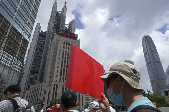 Pro-China supporters hold a placard on their way to protest at the US Consulate in Hong Kong on Sunday, May 31.