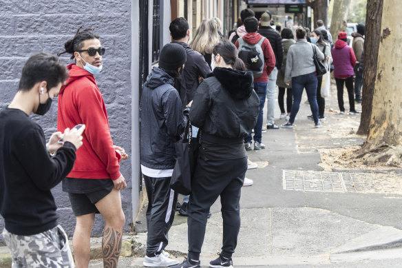 People outside a Centrelink office early in the COVID recession. Higher interest rates often contribute to a lift in unemployment.