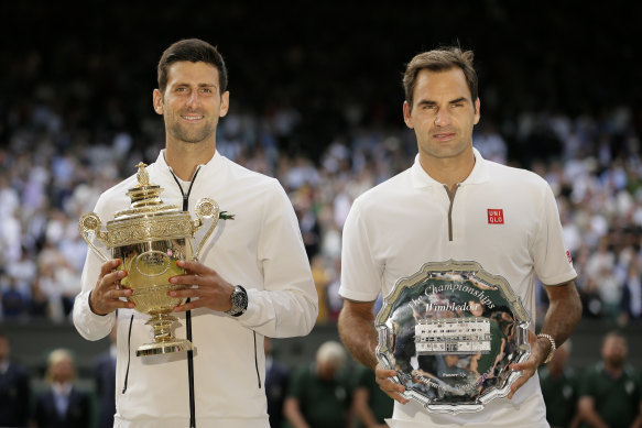 Novak Djokovic and Roger Federer  with the trophies after the Serb’s win in the 2019 Wimbledon final.