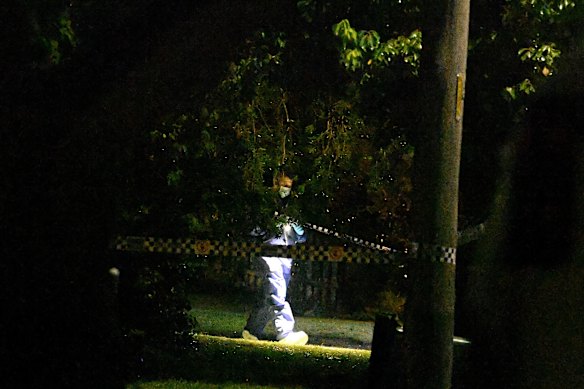 A police forensic officer outside a home where the bodies of woman and two children were found overnight.