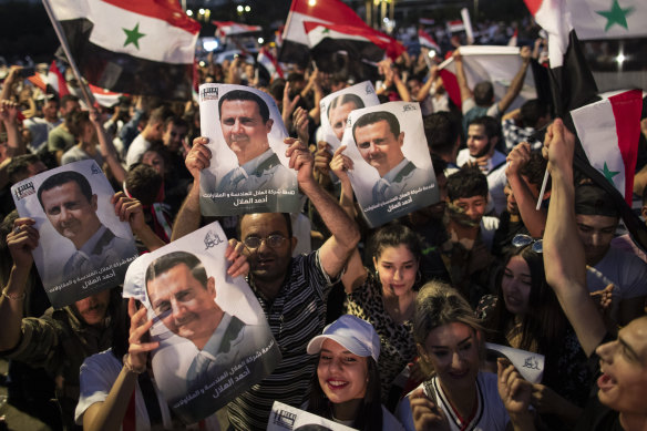 Assad supporters celebrate the results of the national election in Damascus.