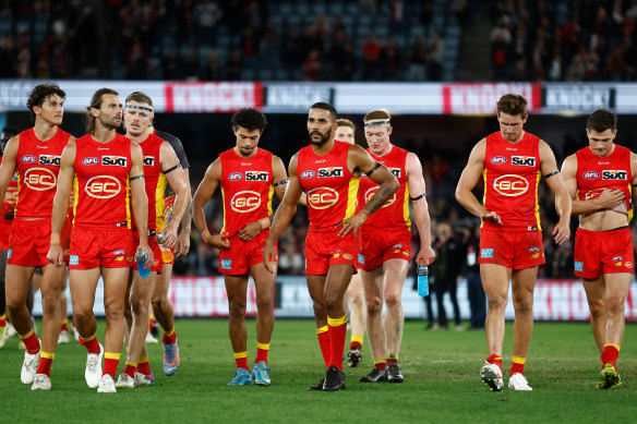 The Suns leave the field after losing to St Kilda.