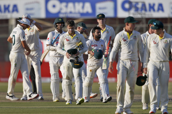 Pakistani and Australian players leave the ground at the end of the play of the second test match between Pakistan and Australia.