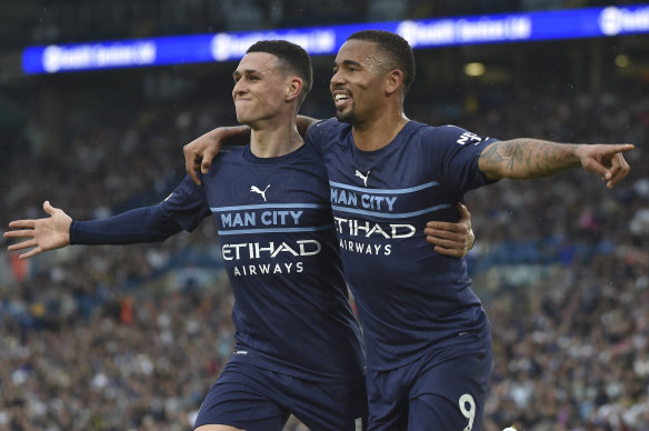 Gabriel Jesus and Phil Foden celebrate City’s third goal.