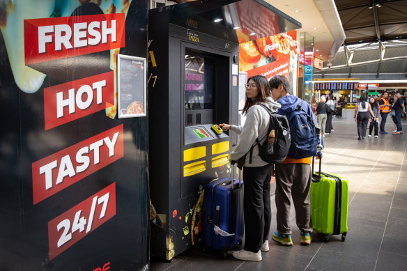 Commuters at Southern Cross Station look at the pizza vending machine on level one.