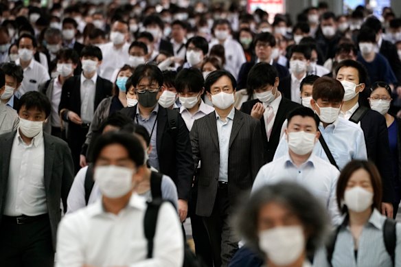 A train station passageway is crowded with commuters in Tokyo last week.