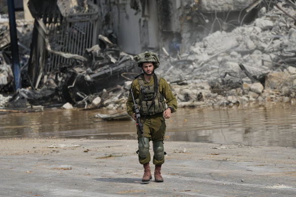 An Israeli soldier walks outside the Sderot police station that was overrun by Hamas militants on Saturday.