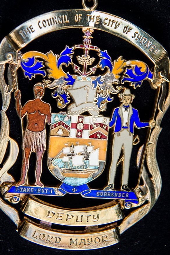 The medallion is inscribed with the phrase "I take but I surrender".