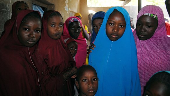 Aishat Alhaji (second right) was among those kidnapped from the government Girls' Science and Technical College Dapchi. She is pictured on Wednesday following her release.