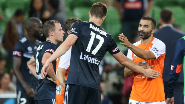 Fahid Ben Khalfallah (right) shakes hands with James Troisi after Roar's win.