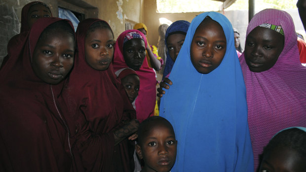 Aishat Alhaji (second right) was among those kidnapped from the government Girls' Science and Technical College Dapchi. She is pictured on Wednesday following her release.