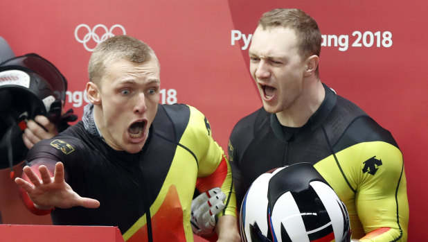 Francesco Friedrich (right) and Thorsten Margis celebrate after they tied for gold.