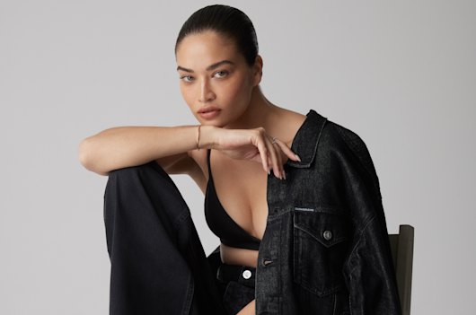 Shanina wears Calvin Klein jacket, $199, and jeans, $199, Coach bralette, $199.