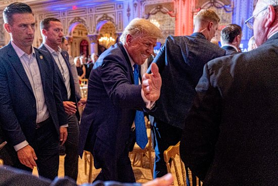 Former president Donald Trump greats guests watching the midterm elections at his Mar-a-Lago residence in Florida.