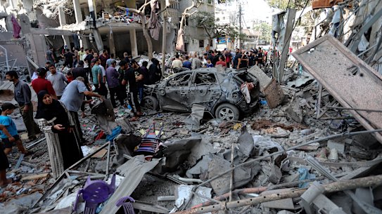 Palestinians inspect the damage of buildings that were hit by Israeli airstrikes, in the Shati refugee camp, Gaza City, Tuesday, Oct. 31.