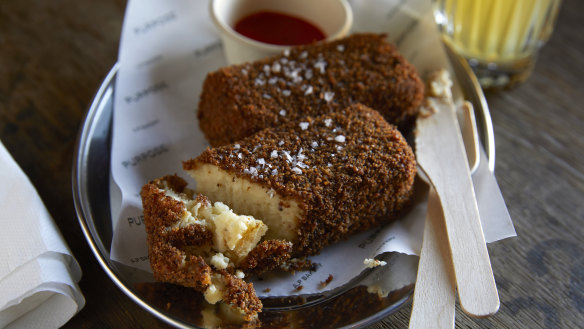 Cheese and cauliflower croquettes with hot sauce. 